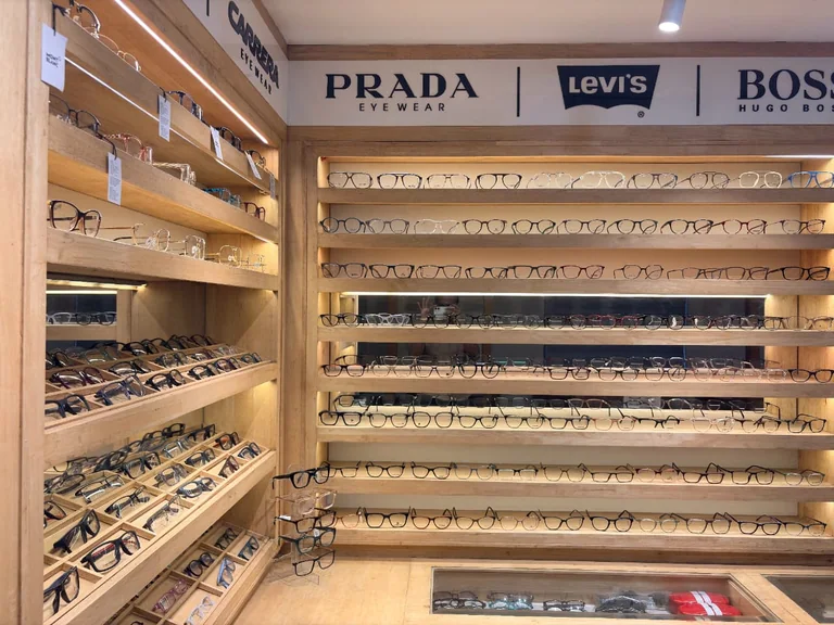 A selection of spectacle frames on illuminated wooden display shelves