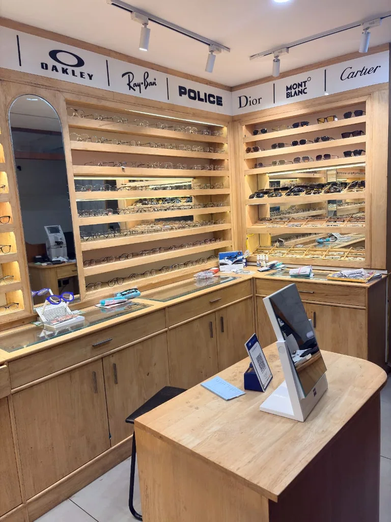 Optical shop interior with an eyewear display, mirror and fitting table